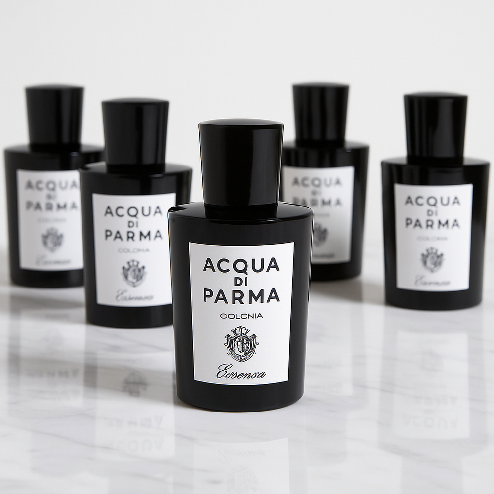 Acqua di Parma cologne bottles on a reflective surface with a light gray background